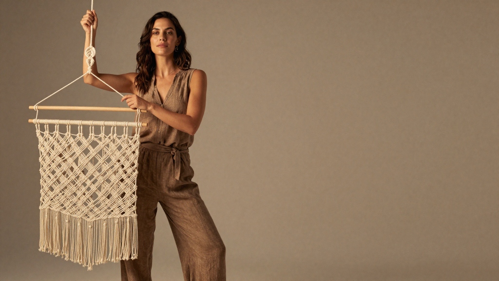 Woman elegantly holding artisanal macrame piece